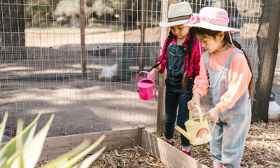 Girls Watering Garden